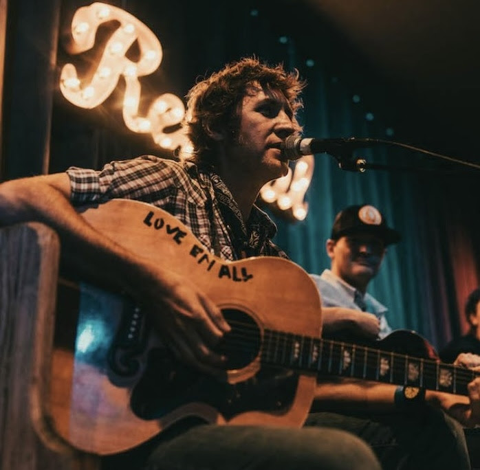 Mac Leaphart's guitar tells you what to do.